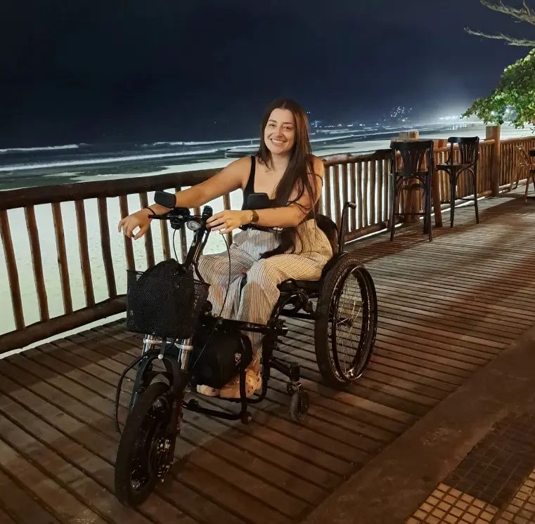 Cliente passeando com o Kit Livre no calçadão à beira-mar